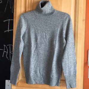 J Crew woman long sleeve turtle neck sweater.
